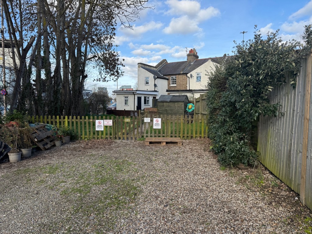 Lot: 11 - END-TERRACE HOUSE FOR IMPROVEMENT - Parking area to the rear of the house
